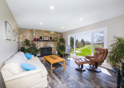 A modern living room with a television, a chair for seating, and a table, designed for comfort and leisure activities.